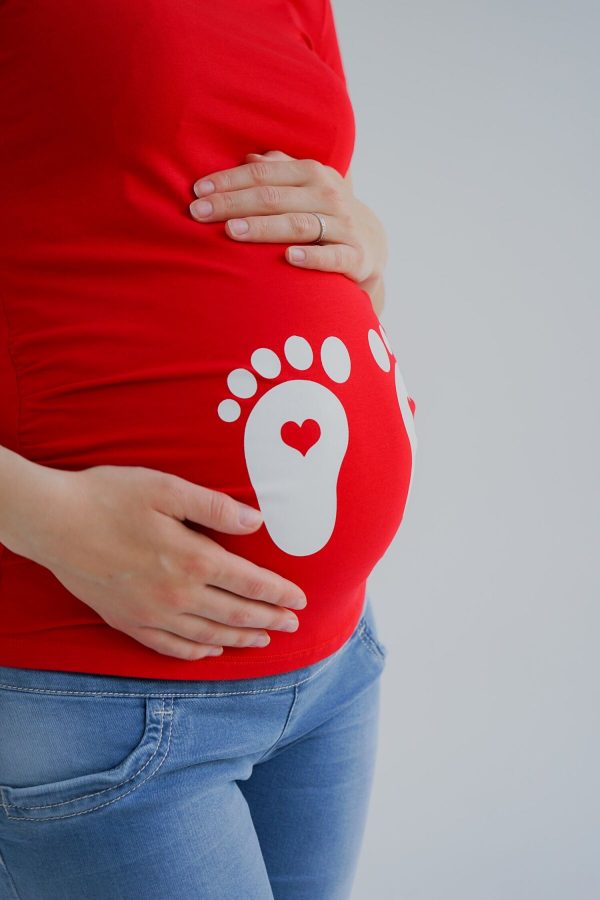 red maternity shirt with white foot print